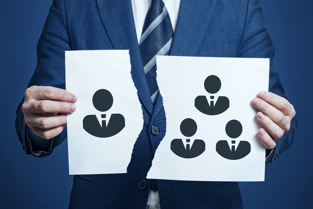 Graphic of a page torn down the middle separating two corporate figures, representing departmental disconnect between a CFO and Controller.