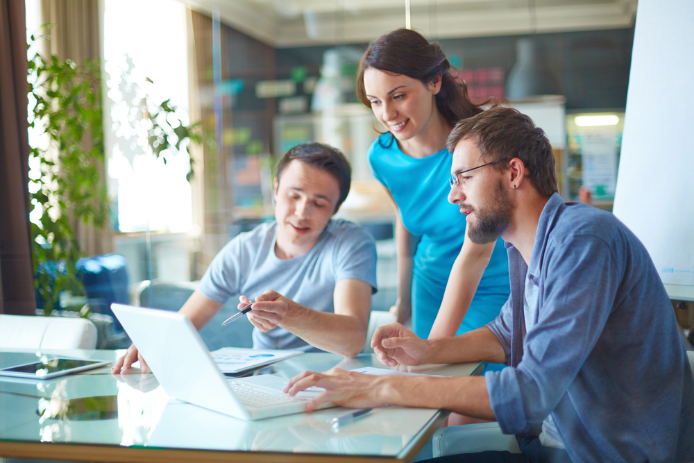 DFW accounting team collaborating happily in a modern office